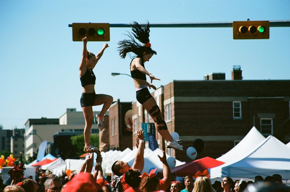 UC Dinos Cheerleaders perform aerials