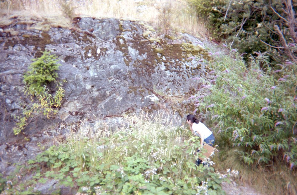 a geology student examines a rock