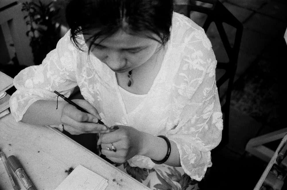 woman carving a stamp in Chengdu