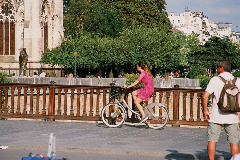 woman on bicycle near Notre Dame in Paris