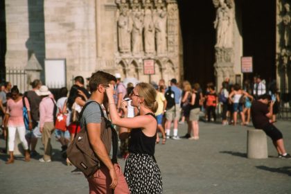 applying lipstick in sunglasses reflection