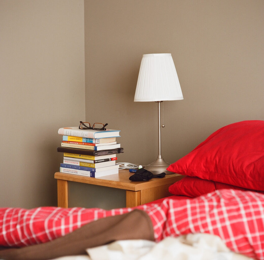 night table, lamp and bed