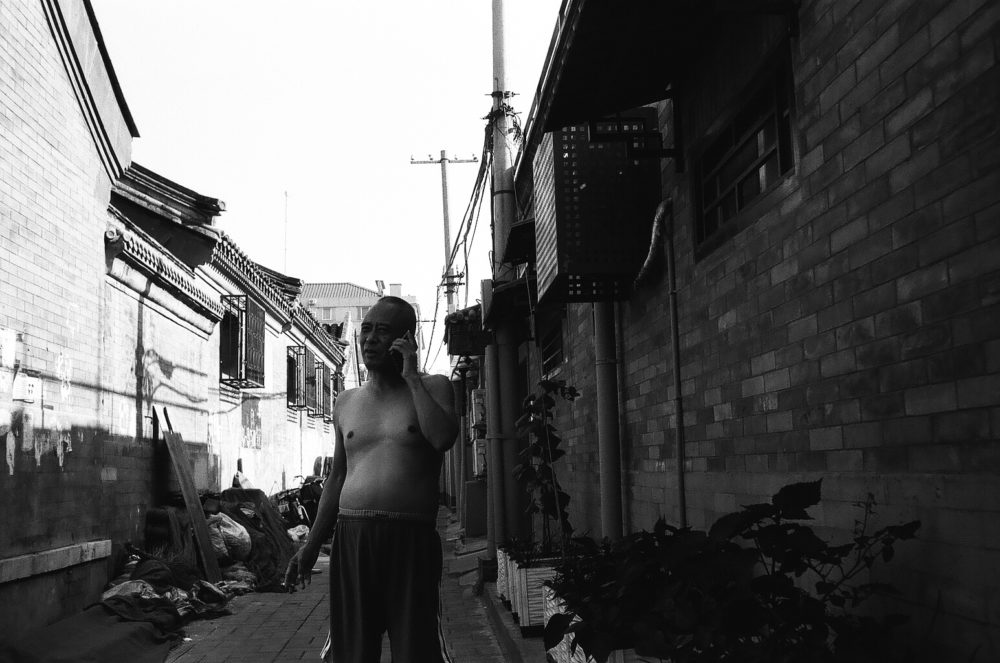 on the phone in a Beijing hutong