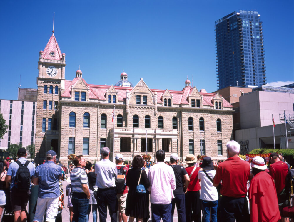 a crowd assembles outside Calgary's city hall
